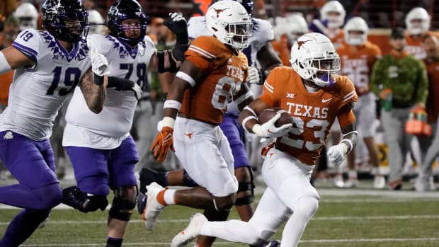Texas Longhorns defensive back Jahdae Barron (23) runs for a touchdown after recovering a fumble against the Texas Christian Horned Frogs during the second half at Darrell K Royal-Texas Memorial Stadium